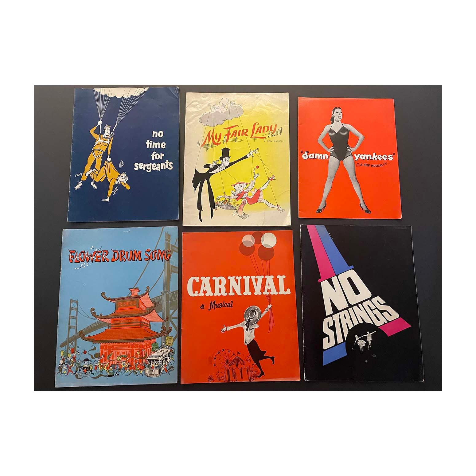 Collection of original official souvenir programmes for Broadway theatres. Includes My Fair Lady at Mark Hellinger Theatre (1956), No Time for Sergeants at Neil Simon Theatre (1955), No Strings at 54th Street Theatre (1963), and Flower Drum Song at St James Theatre (1958).