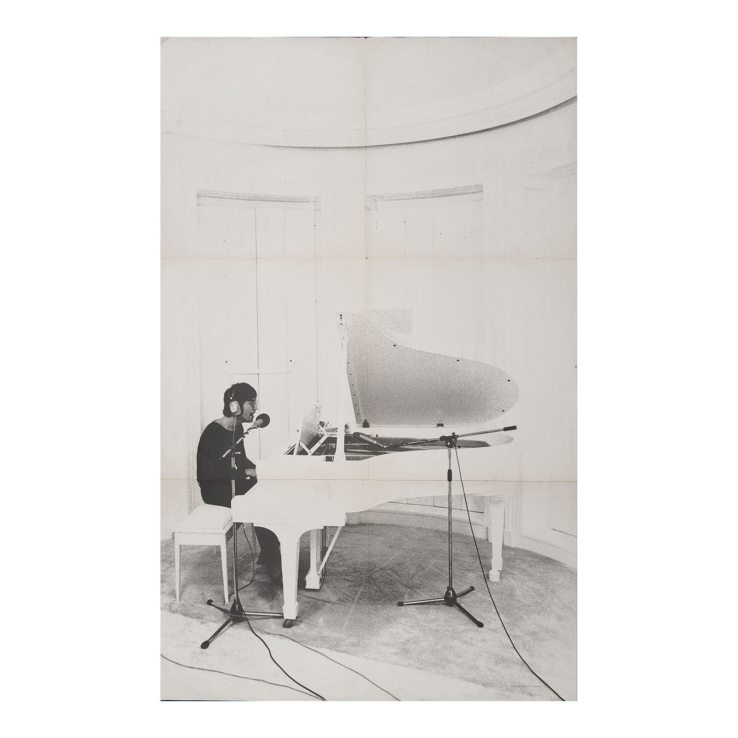 promotional poster for Imagine, the second solo studio album by John Lennon, released on 9 September 1971 by Apple Records. The artwork features a photograph of Lennon at the piano taken by Yoko Ono using a Polaroid camera