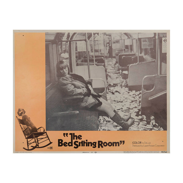 Original lobby card for the cinematic release of The Bed Sitting Room, 1969. The black comedy, directed by Richard Lester, starred an ensemble cast of British comic actors, and was set against the background of a post-apocalyptic London. The lobby card features a photograph of the actor Rita Tushingham, seated in a litter strewn Underground carriage