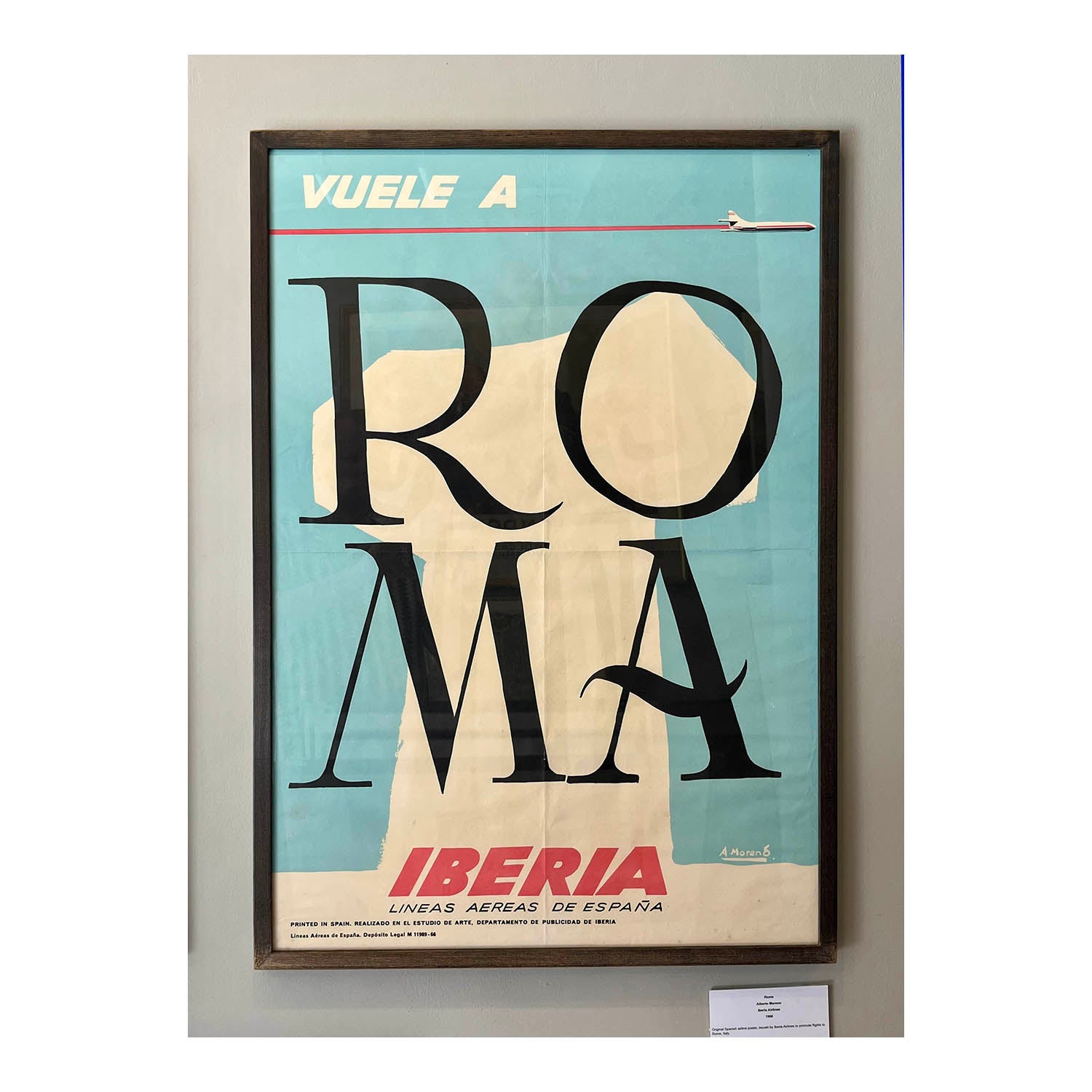 An original, vintage, travel poster designed by Alberto Moreno for the Spanish airline Iberia,&nbsp; promoting flights to Rome, 1966. The design depicts a classical Roman column with large letters ROMA on a light blue background