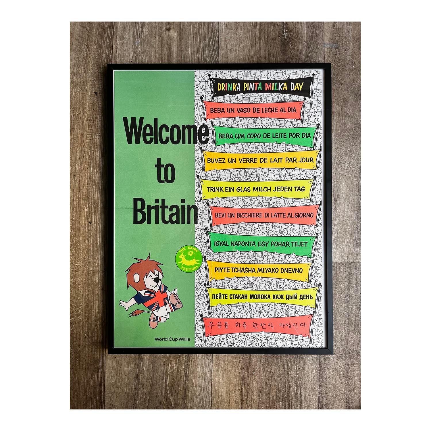 England World Cup tie-in advertising poster, Welcome to Britain, published by the Milk Marketing Board (MMB) in 1966. The poster features the 1966 FIFA World Cup tournament mascot, World Cup Willie, alongside the MMB’s slogan "Drinka Pinta Milka Day" translated into nine further languages
