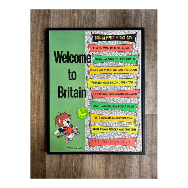 England World Cup tie-in advertising poster, Welcome to Britain, published by the Milk Marketing Board (MMB) in 1966. The poster features the 1966 FIFA World Cup tournament mascot, World Cup Willie, alongside the MMB’s slogan "Drinka Pinta Milka Day" translated into nine further languages