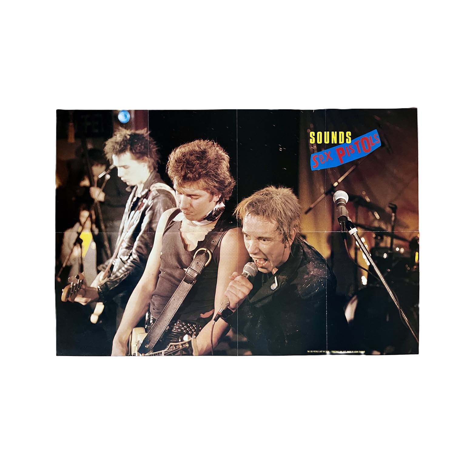 Original double-sided pull-out magazine poster, The Sex Pistols Last UK Show, Christmas Day 1977, photographed by Kevin Cummins and published in Sounds magazine, c.1985. The reverse lists Sounds ‘all time 100 singles’.