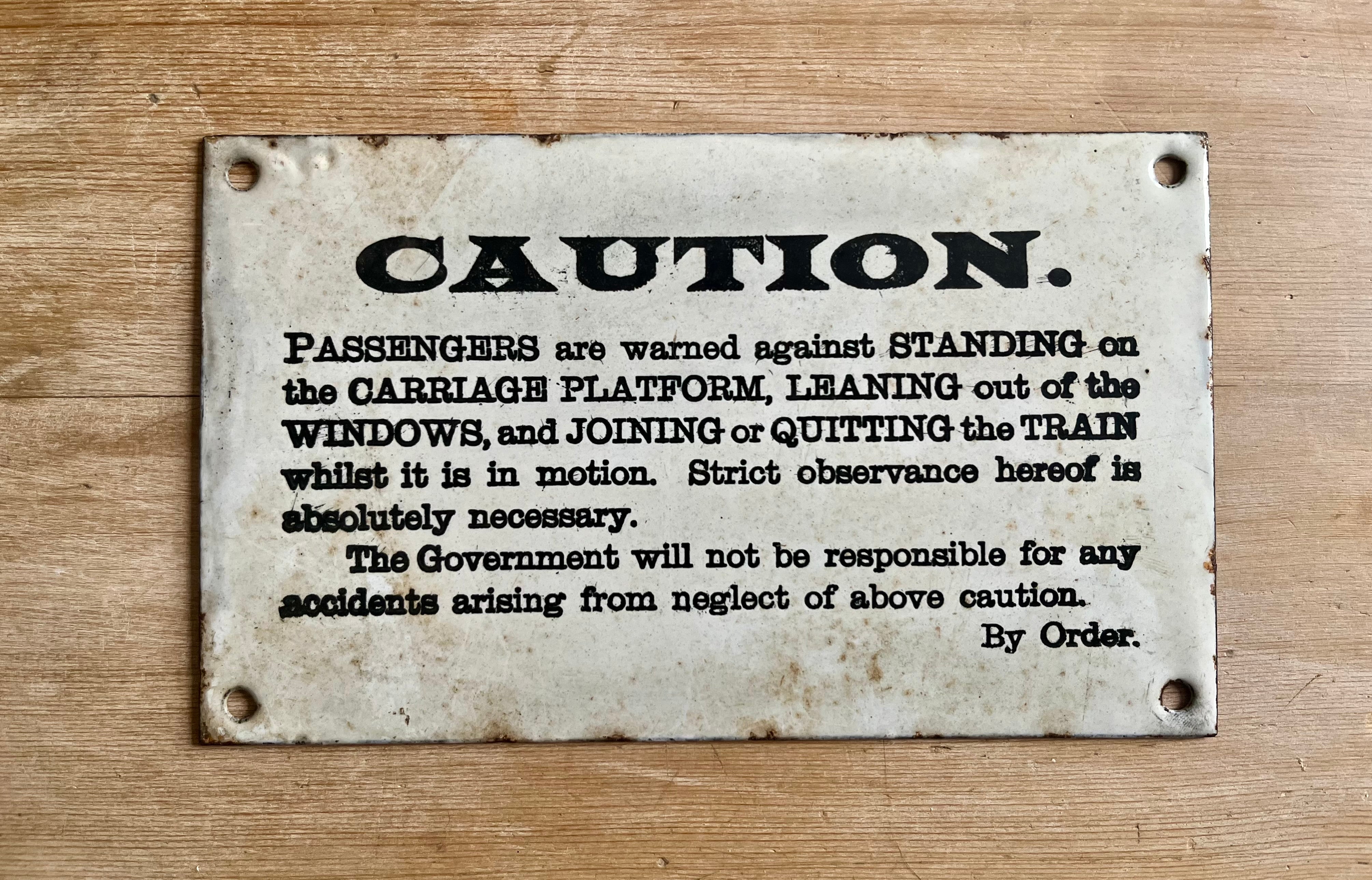 Original enamel railway sign warning passengers against standing on the carriage running boards, leaning out of windows or attempting to join or quit the train in motion