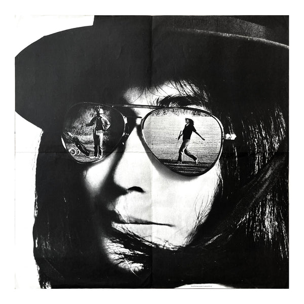Promotional poster for Mrs. Lennon, Yoko Ono's first single from her second studio album Fly, released in 1971. The photomontage design features Ono and Lennon reflected in Ono’s trademark sunglasses. 